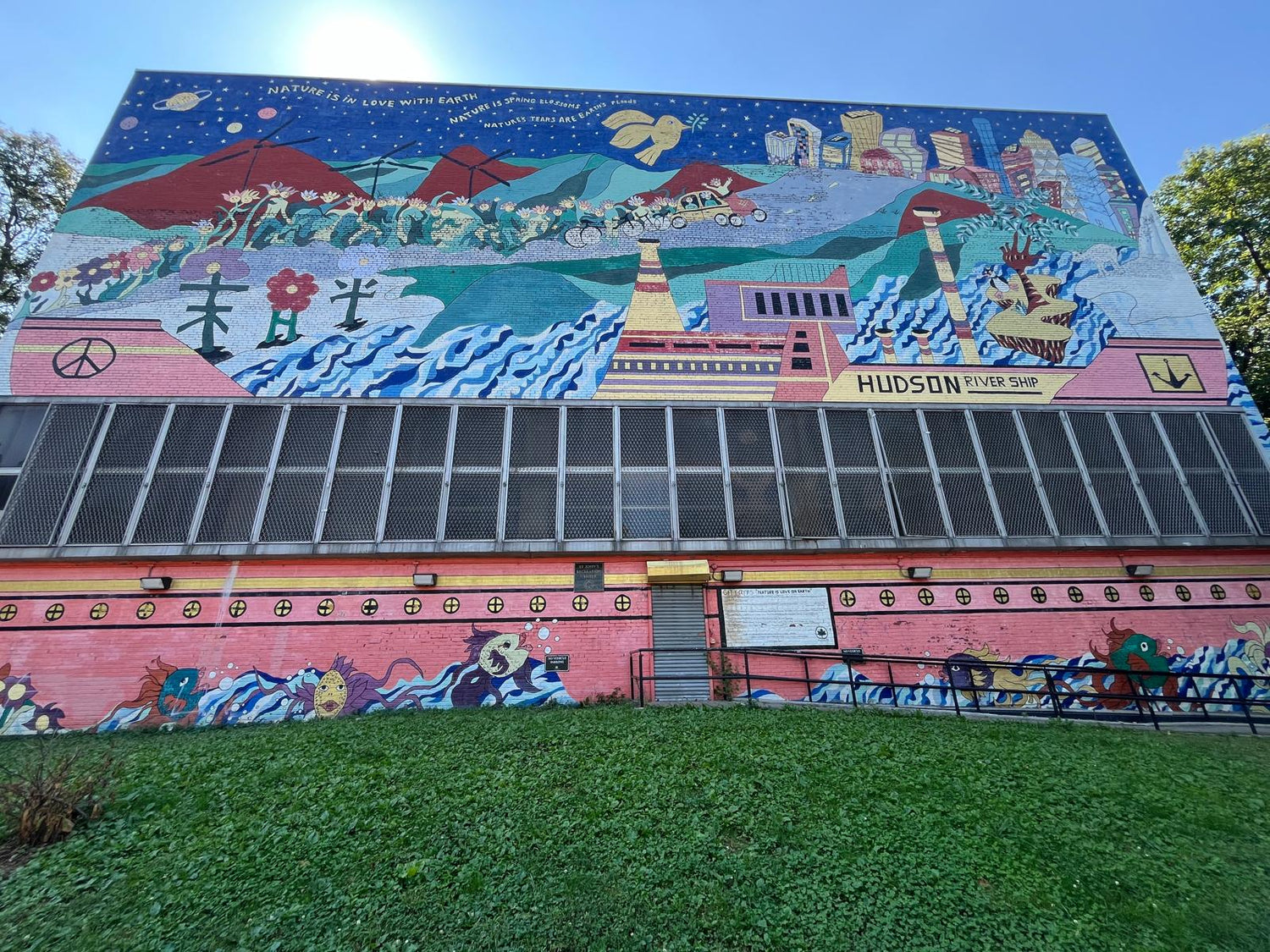 Colorful Hudson River mural in Crown Heights, blending nature, community, and city life into one vibrant artwork. 